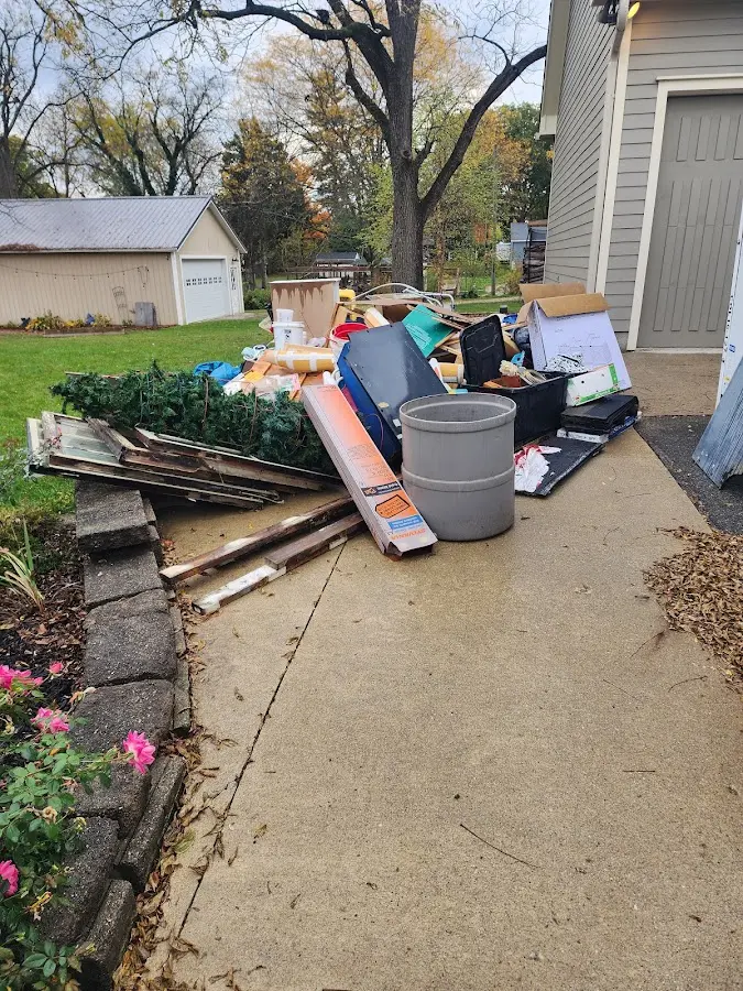 Dumpster being loaded with debris for Estate Cleanout Dumpster Rental in Crest